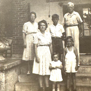 Don Lohrentz (white overalls) on the Inn porch with his family In 1943